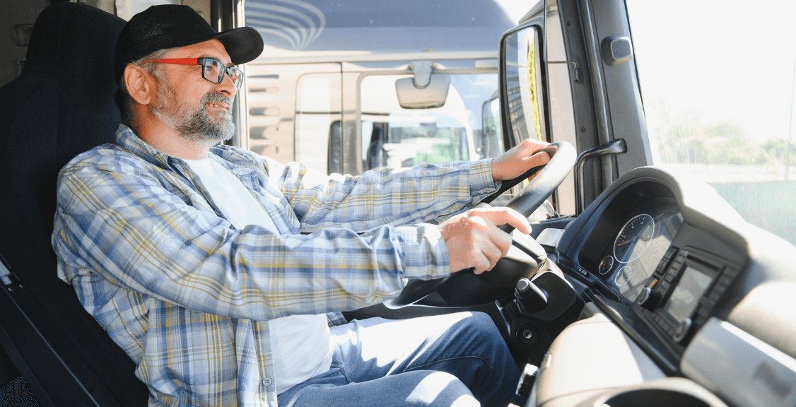 a driver smiling while driving the truck