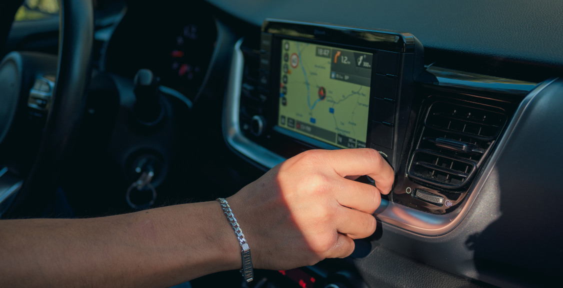 Close-up of a man touching the buttons on the screen of a car