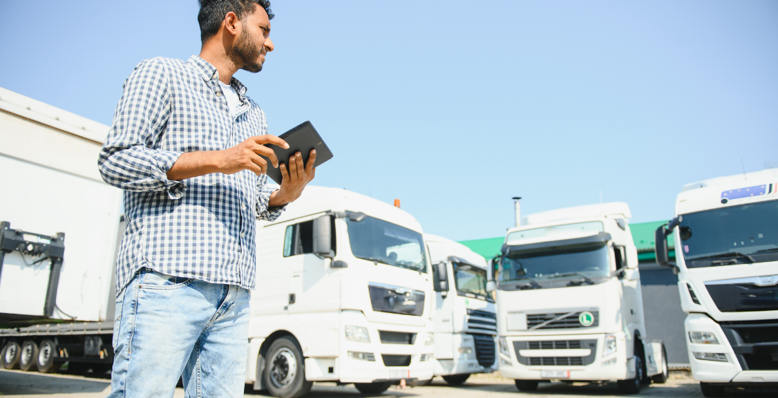 driver checking fleet of trucks using gps tracking