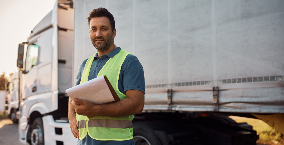 Portrait of freight transportation manager on truck parking lot looking at camera. Portrait of freight transportation manager on truck parking lot looking at camera.