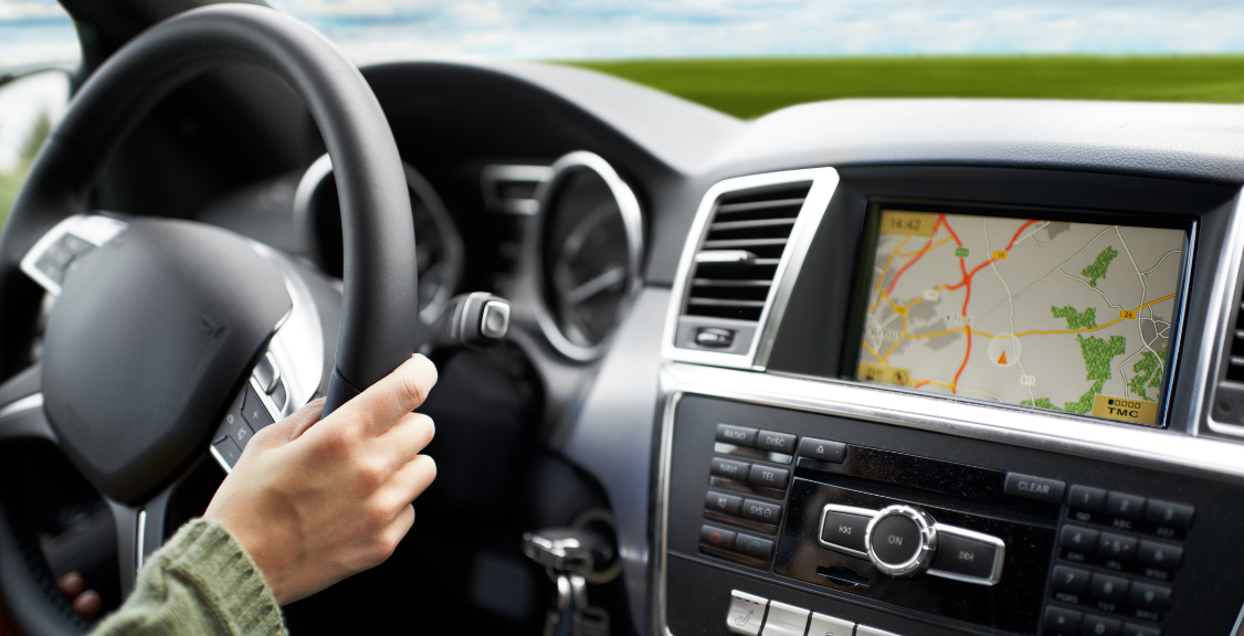 Cropped shot of a person traveling by car using the on-board GPS to navigate