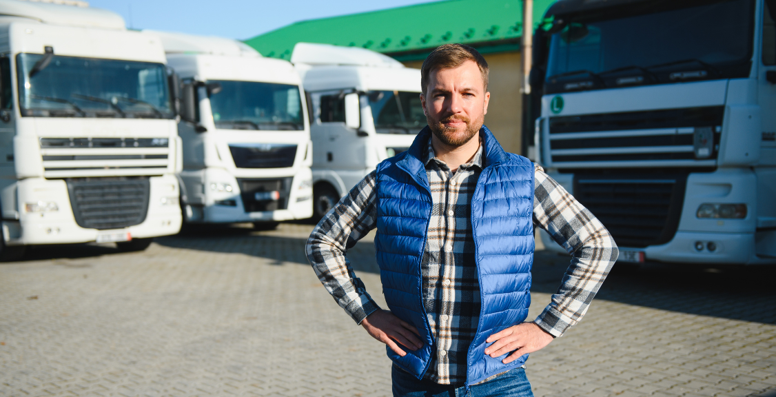 Freight transportation. A truck driver stands on the background of a truck