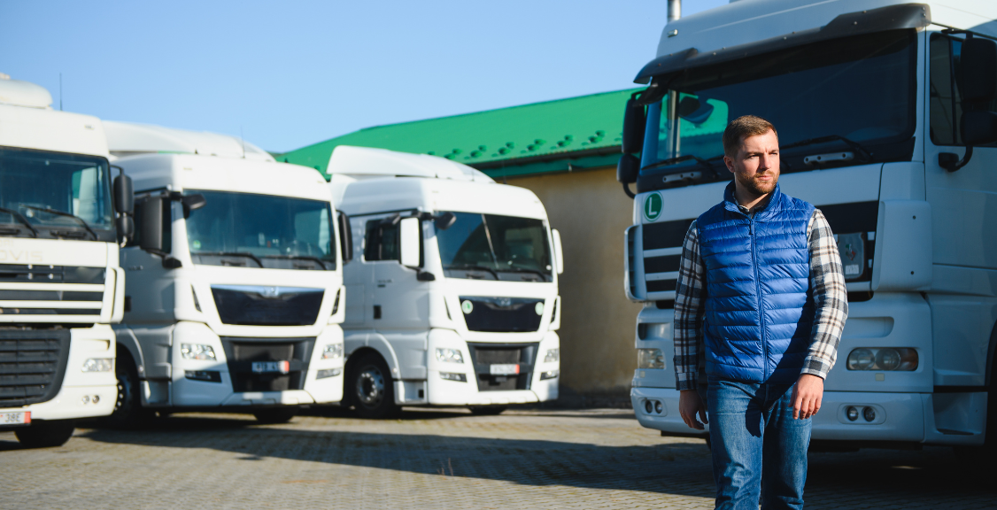 Freight transportation. A truck driver stands on the background of a truck