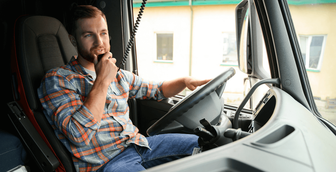 a fleet manager checking the condition of truck and reporting to management