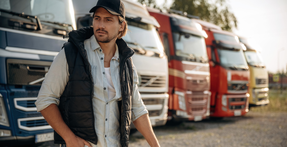 Model in cap is posing. Truck driver is near the transport outdoors