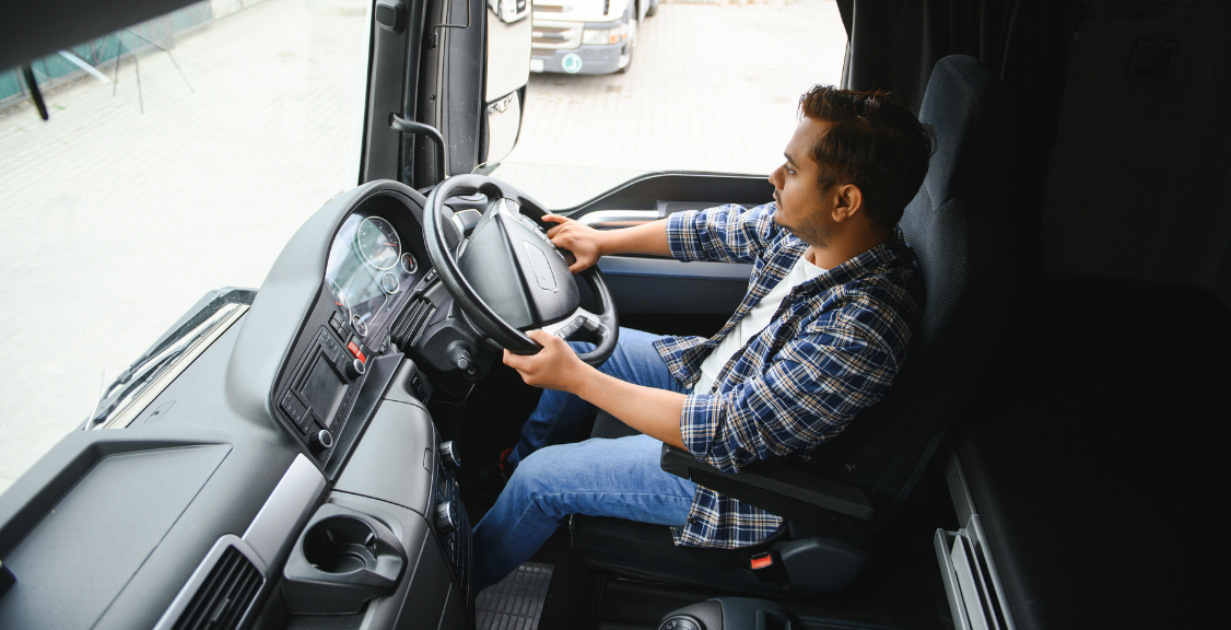 Portrait of a Young Handsome Indian Truck Driver. the Concept of Logistics and Freight Transportation.