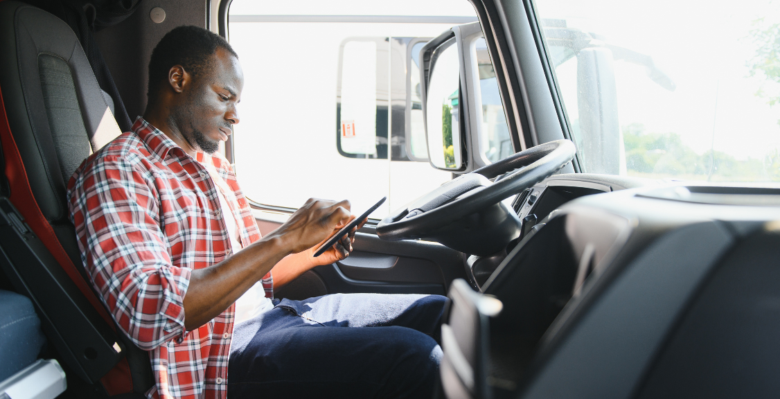 a driver working on a tablet checking on gps tracking