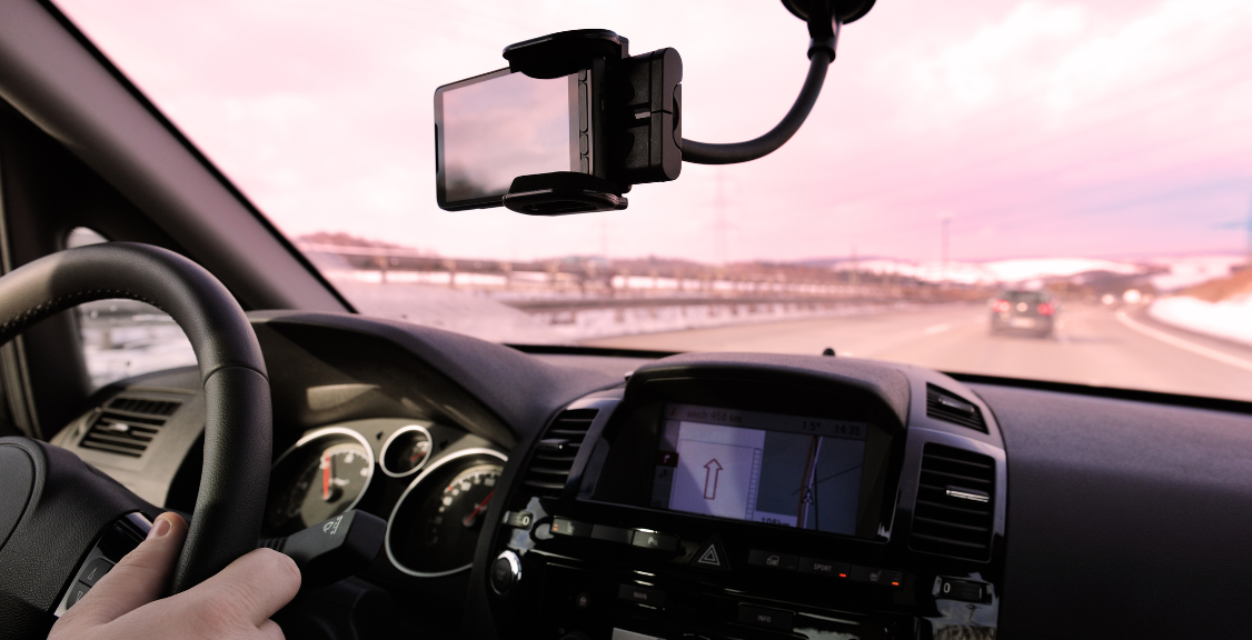 a man driving a car and using telematics