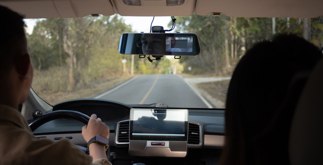 a man driving a car while using a dashcam telematics