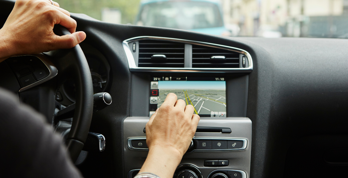 a man in a car using gps system