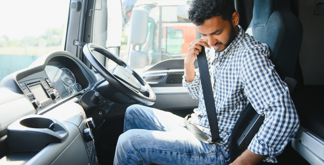a truck driver puting seat belt