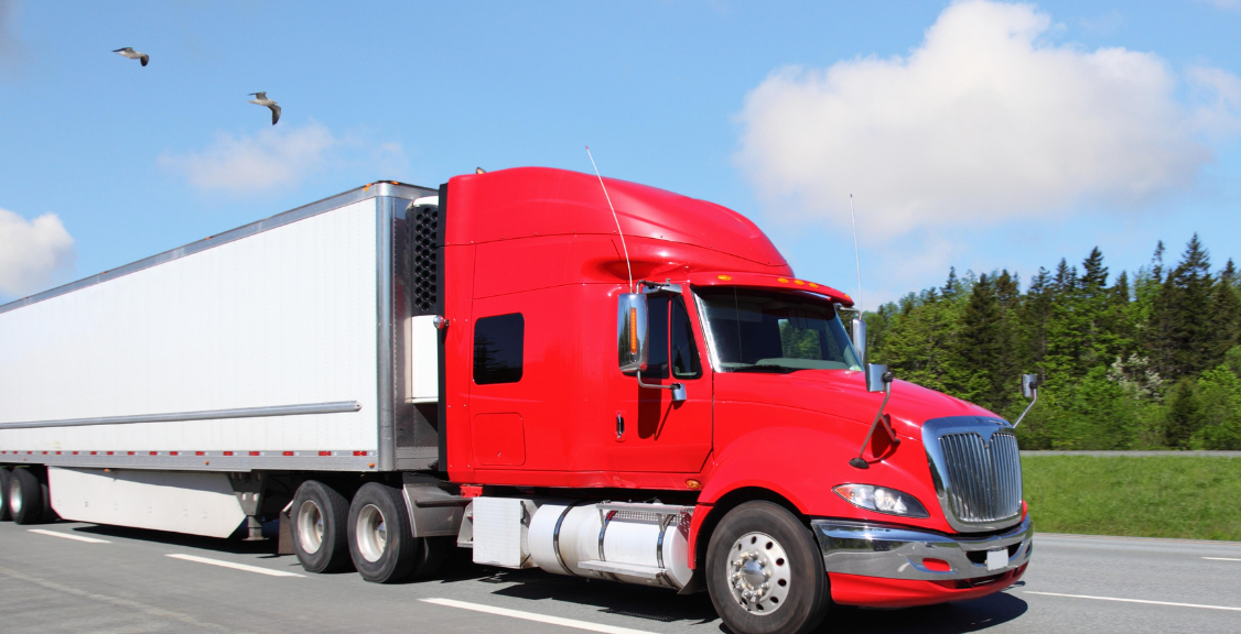 large truck color red on a road